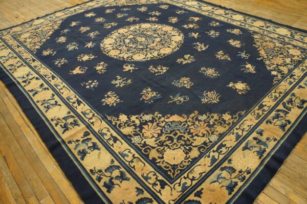 Wool hand knotted pile blue antique rectangle 1890s rug 2 Large square rug in dark blue with intricate central medallion and beige borders on wooden floors.