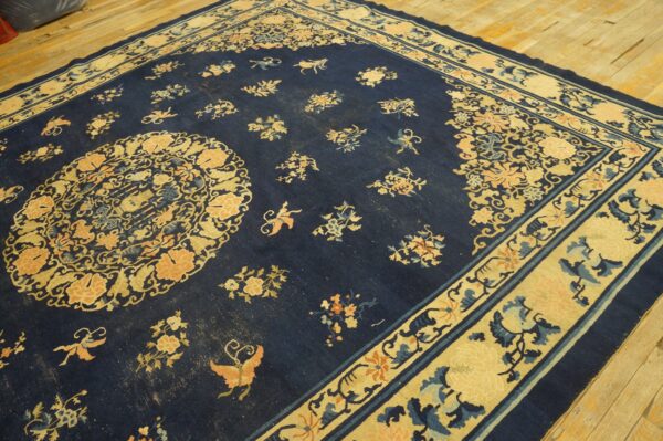 Wool hand knotted pile blue antique rectangle 1890s rug 6 Dark blue rug with beige and peach floral motifs, a central medallion, and a thick contrasting border.