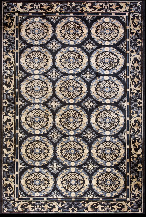 Black rug featuring repeating circular beige and blue floral medallions and a detailed border.