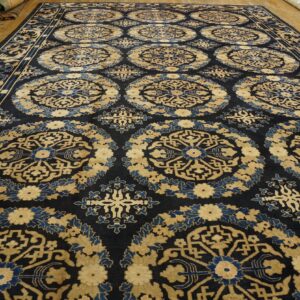 Ornate navy rug featuring repeating circular motifs in gold and medium blue on a wood plank floor.