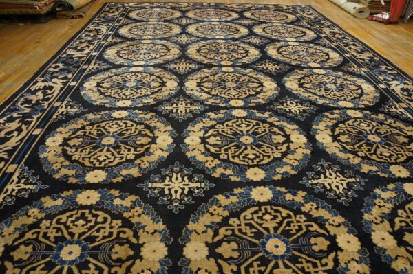 Ornate navy rug featuring repeating circular motifs in gold and medium blue on a wood plank floor.
