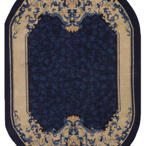 Oval blue and beige rug featuring an elaborate, traditional floral design and a solid navy border.