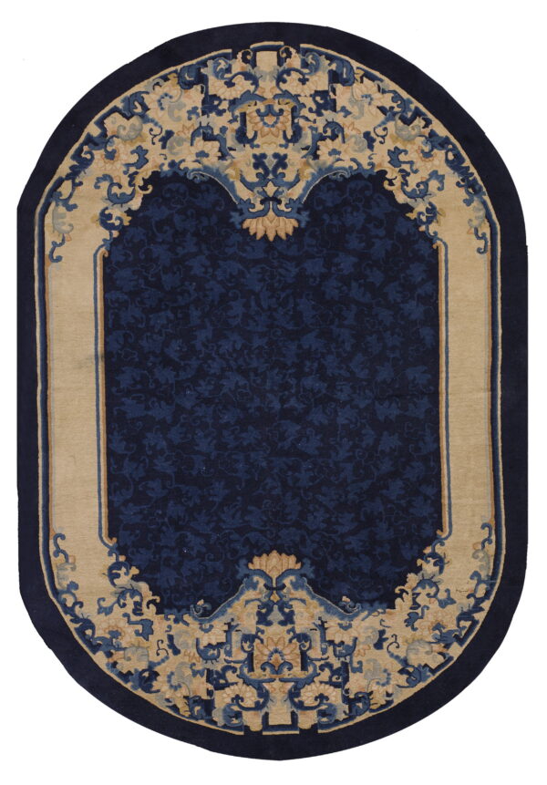 Oval blue and beige rug featuring an elaborate, traditional floral design and a solid navy border.