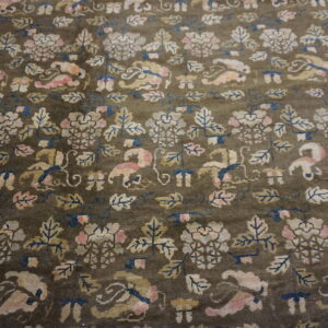 Muted olive rug featuring a dense floral pattern with pink, cream, blue, and gold motifs.