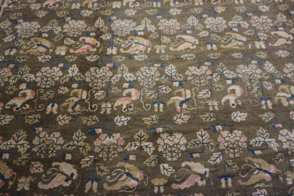 Muted olive rug featuring a dense floral pattern with pink, cream, blue, and gold motifs.
