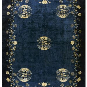 A dark blue rug featuring five golden circular bird motifs framed by an elaborate floral vine border.