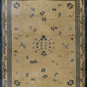 A low pile rug featuring a gold field, scattered blue floral sprays, and a dark blue geometric border.