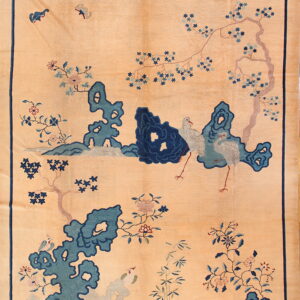 Light tan rug featuring a scenic pattern of blue scholar rocks, flowering branches, and white cranes.
