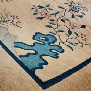 High-pile tan rug featuring stylized floral and cloud motifs in dark and light blue accents.