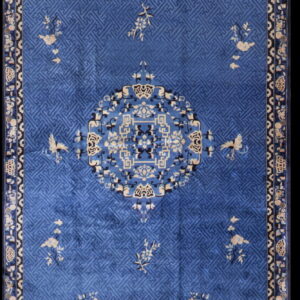 Cobalt blue runner rug with a central medallion, geometric background pattern, and cream floral accents.