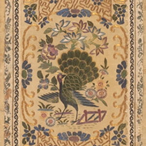 Vertical beige textile panel displaying a peacock, butterfly, blue flowers, and intertwining geometric gold lines.
