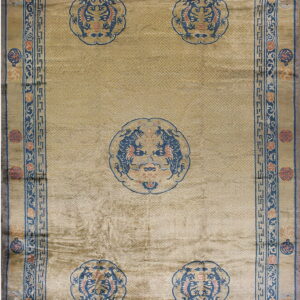 Lustrous gold rug featuring five blue dragon medallions over a subtle geometric lattice pattern.