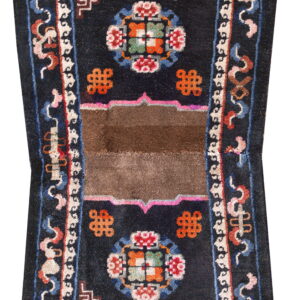 Black runner rug featuring elaborate multicolored borders framing a central brown band across the pile.