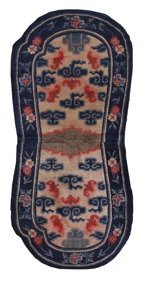 Contoured rug featuring a beige field with red and blue chinese cloud patterns and a navy floral border.
