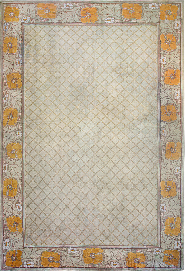 Light green rug featuring a subtle trellis pattern field and bold borders with large orange flowers.