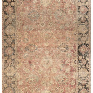 Faded, low-pile rug featuring a rose-red central field and wide dark borders with traditional floral patterning.
