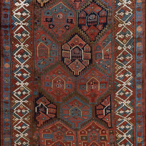 Geometric tribal runner rug featuring repeating stylized terracotta and blue motifs within wide diamond borders.