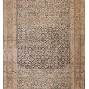 Traditional runner rug featuring a faded navy blue and tan pattern with intricate borders.