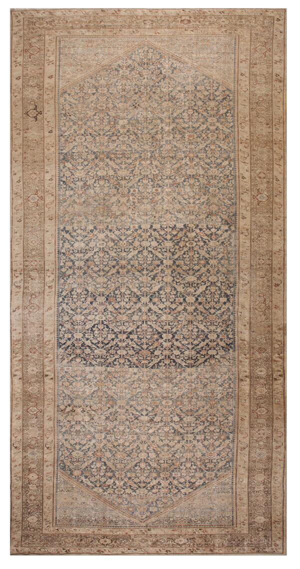 Traditional runner rug featuring a faded navy blue and tan pattern with intricate borders.