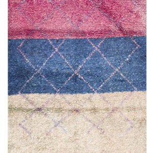Textured, high-pile rug with horizontal blocks of pink, blue, and cream and a contrasting diamond pattern.