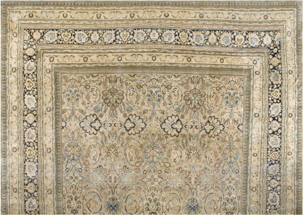 Intricate low-pile rug featuring light beige, blue, and brown traditional floral medallions and multiple borders.