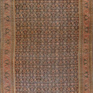 Traditional dark rug with a dense repeating floral pattern and wide ornate border in muted orange and peach tones.