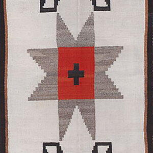 White flatweave runner with large red, gray, and black serrated star motifs and a dark border.