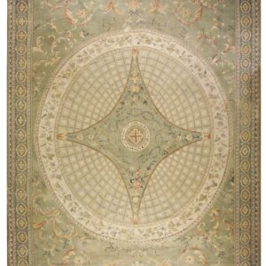 Ornate light green rug featuring a detailed central cream medallion and scrolling gold leaf patterns.