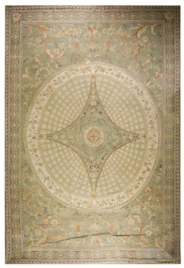 Ornate light green rug featuring a detailed central cream medallion and scrolling gold leaf patterns.