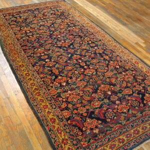 Long runner with navy and red floral pattern and yellow borders rests on light wood flooring.