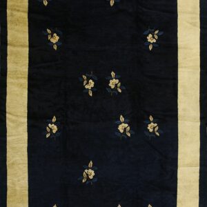 Dark blue rug featuring scattered pale yellow floral sprigs and a wide golden-tan border.