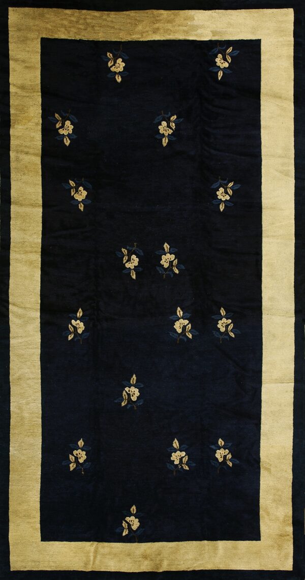 Dark blue rug featuring scattered pale yellow floral sprigs and a wide golden-tan border.