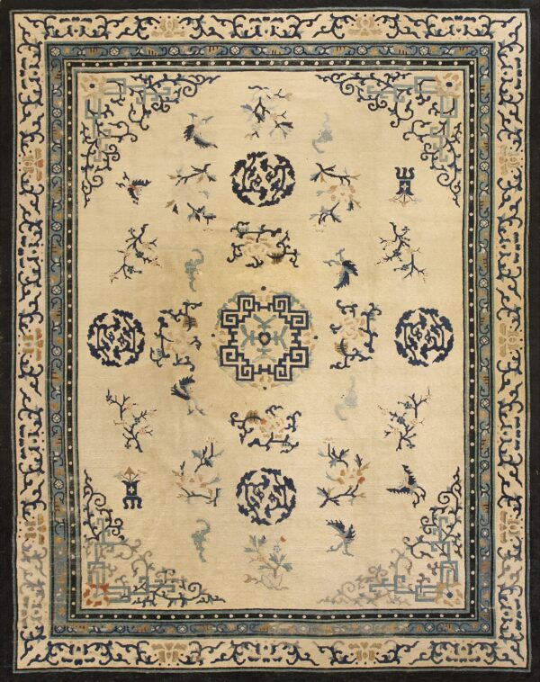 Ivory rug with scattered stylized blue, teal, and tan motifs framed by intricate dark blue borders.