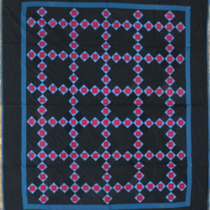 A black textile with a geometric lattice pattern of red squares and blue diamonds, bordered in teal.