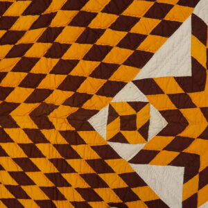 Low-pile quilted textile featuring a brown, gold, and white radiating geometric diamond pattern.