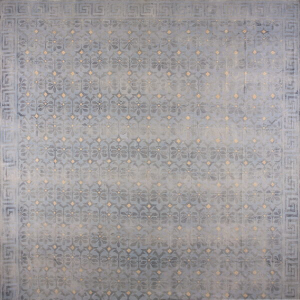 Muted blue distressed rug with a lattice floral pattern, tan accents, and a greek key border.