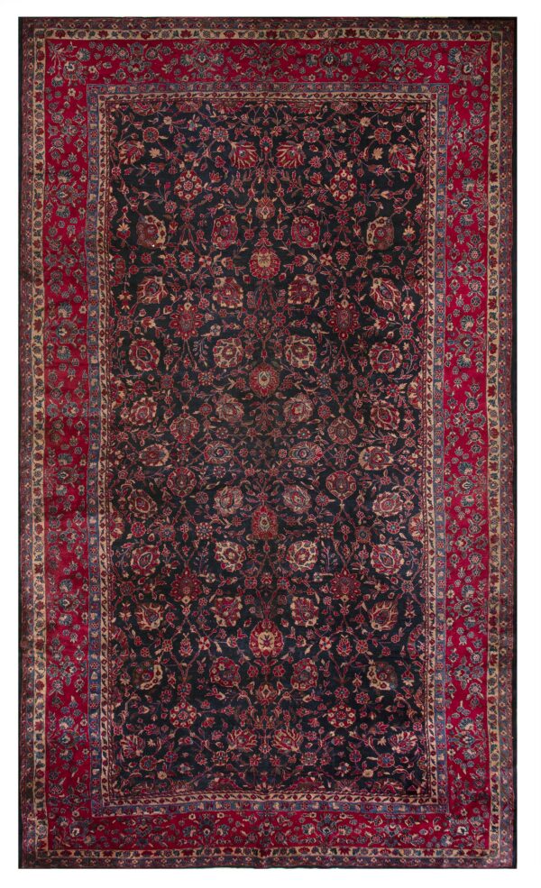 Navy rug with elaborate red, blue, and gold floral patterns surrounded by a wide primary red border.