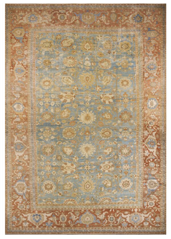 Ornate floral rug with a pale blue field and a wide brick red patterned border.