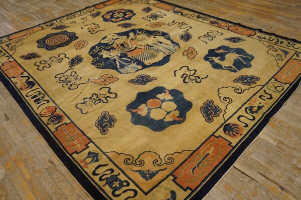 Low-pile tan rug featuring navy and orange traditional figures, clouds, and bordered medallions on wood planks.
