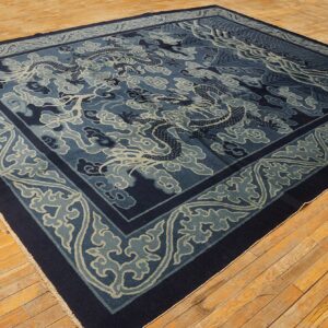 A large blue rug with a complex dragon, cloud, and wave pattern rests on light wood plank flooring.