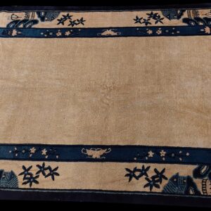 Low-pile beige rug with a wide blue and navy blue border displaying detailed pictorial motifs.