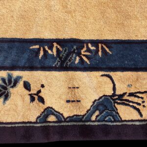 High-pile beige rug with dark blue floral and landscape motifs in stacked horizontal borders.