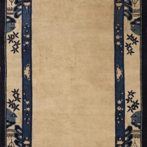 Tan rug featuring a stylized navy blue border with low-relief designs of ships, pagodas, and flowers.