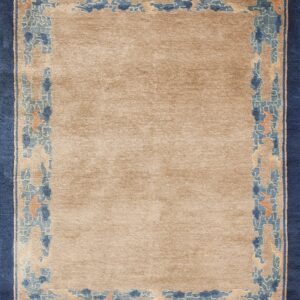 Beige rug featuring a detailed blue, light blue, and orange patterned border and a solid navy edge.