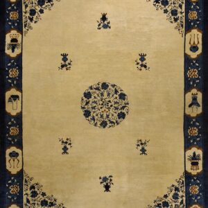 Light beige rug featuring a dark blue central floral medallion and a wide border with stylized object motifs.