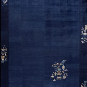 A deep navy blue rug featuring stylized vases and flower motifs in cream and light blue on the border and field.