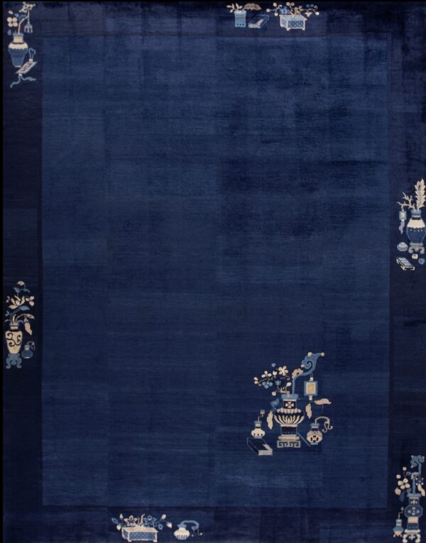 A deep navy blue rug featuring stylized vases and flower motifs in cream and light blue on the border and field.