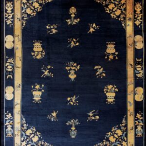 Detailed dark blue rug with scattered gold floral vases and birds inside a wide gold border.