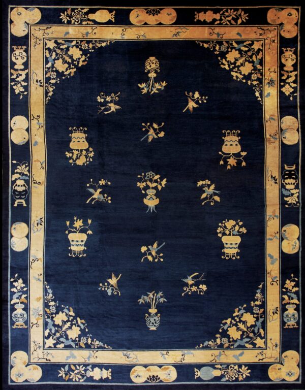 Detailed dark blue rug with scattered gold floral vases and birds inside a wide gold border.