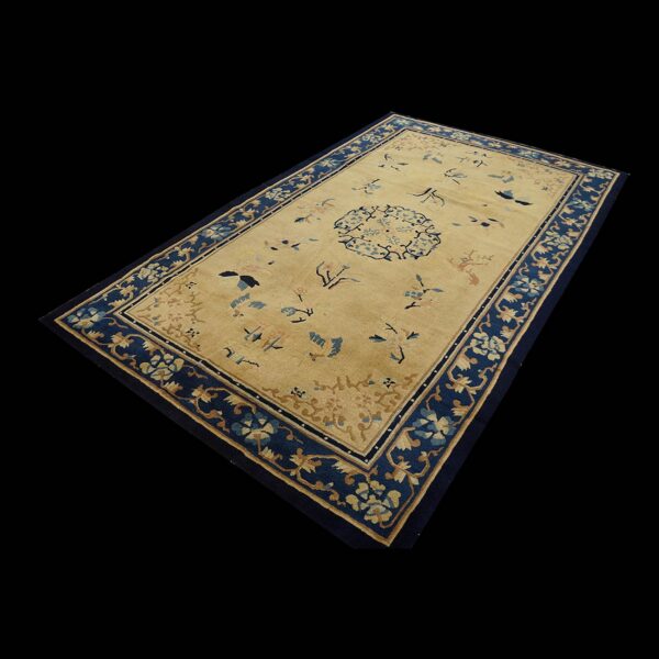Antique peking chinese floral beige 1890s rug 1 Gold rectangular rug with scattered blue and tan motifs and a wide navy floral border.
